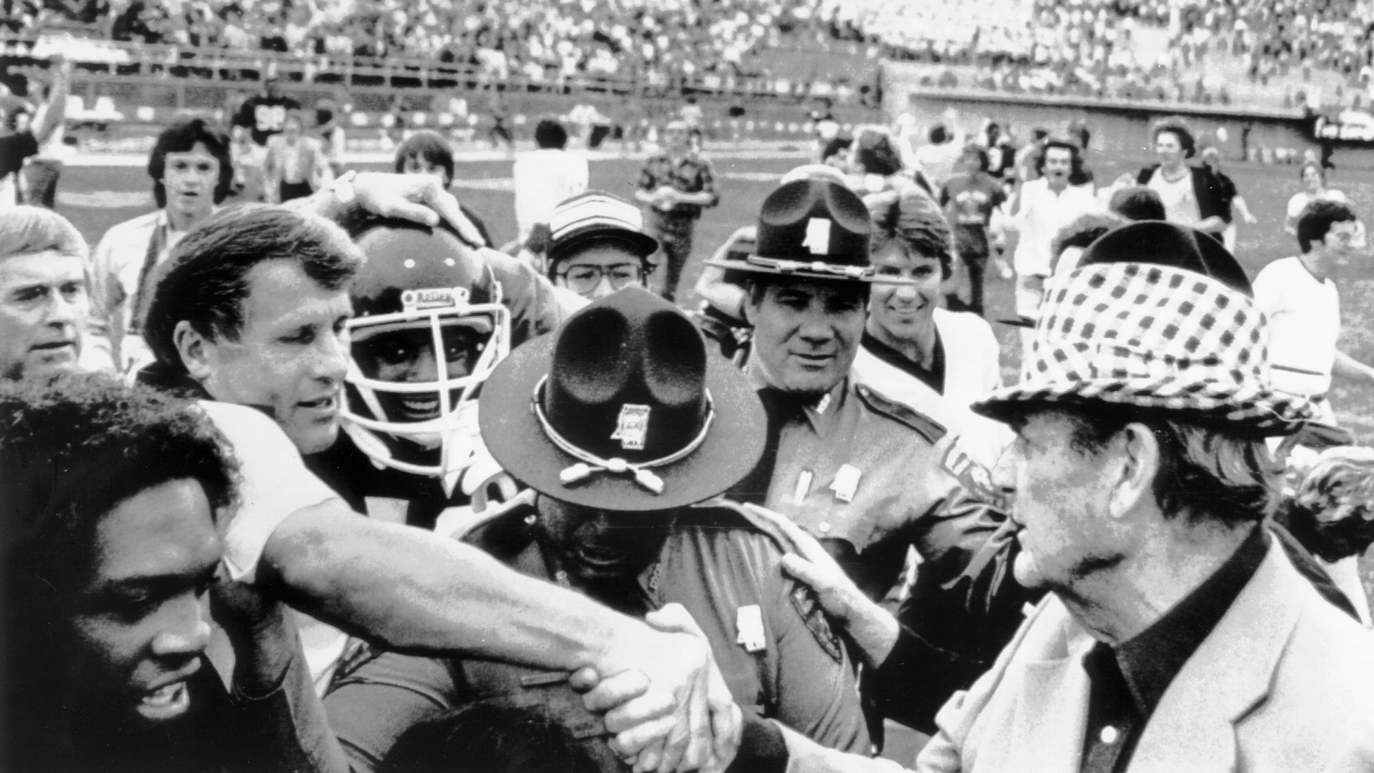 Mississippi State coach Emory Bellard greets Alabama coach Bear Bryant after the Bulldogs' 6-3 victory in 1980