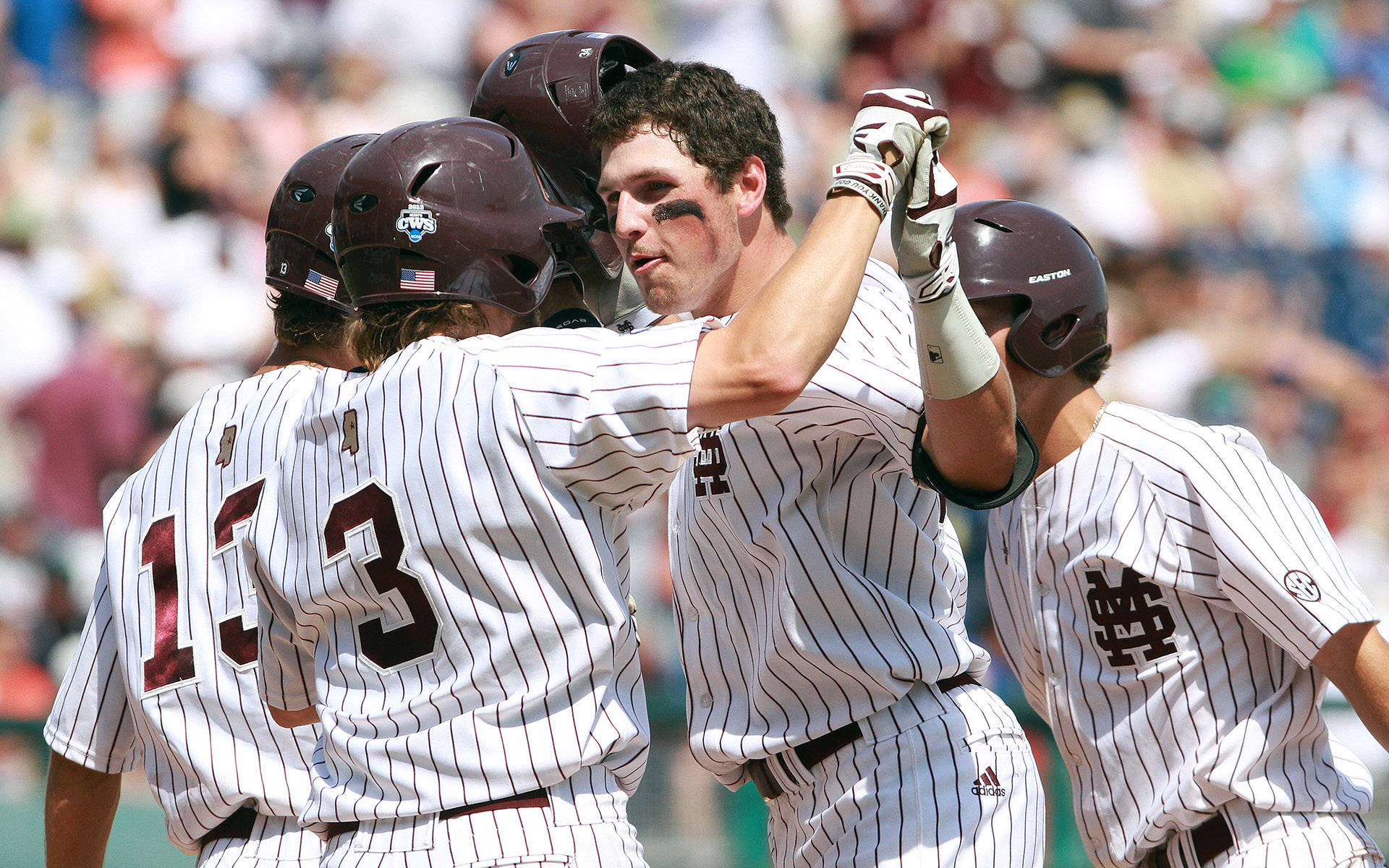 Mississippi State baseball players celebrate during the 2013 College World Series in Omaha